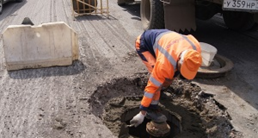 В Волгограде ливневые колодцы поднимают из полуметрового слоя асфальта